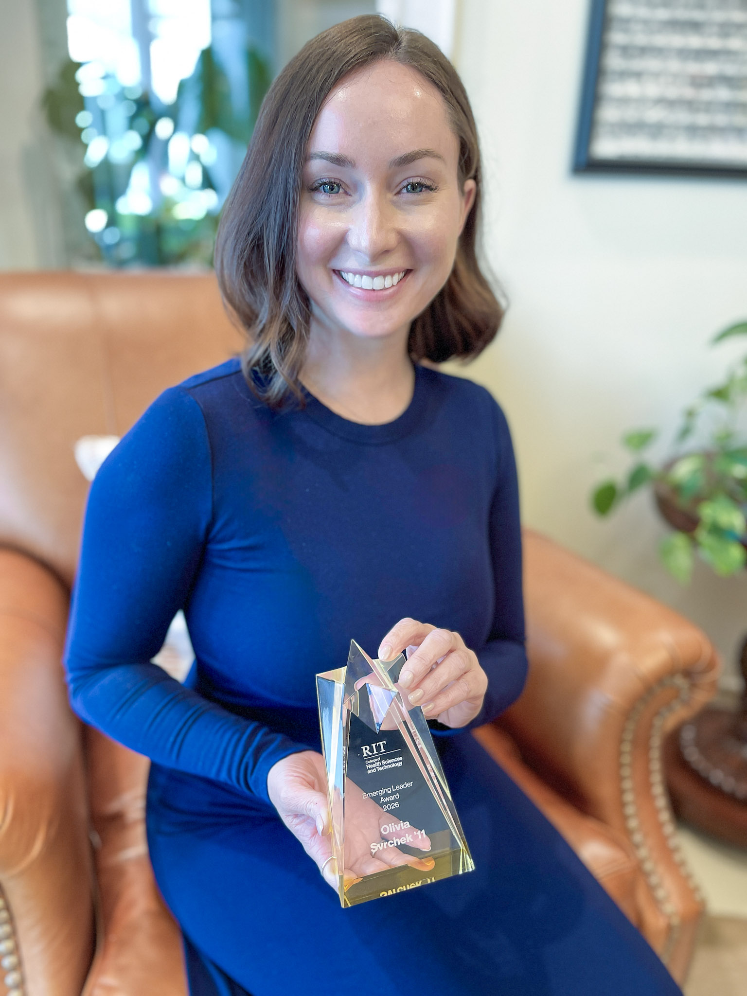 Olivia Svrchek holding the RIT Emerging Leader Award